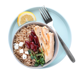 Photo of Tasty brown rice with beans and chicken meat isolated on white, top view