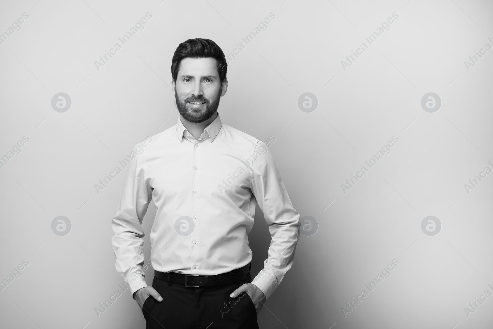 Image of Portrait of handsome man on light background, space for text. Black and white effect