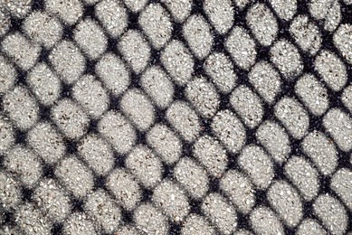 Photo of Pattern made with shadow of fence on asphalt
