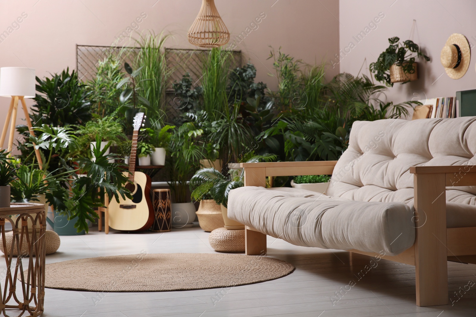Photo of Living room interior with stylish furniture and different houseplants