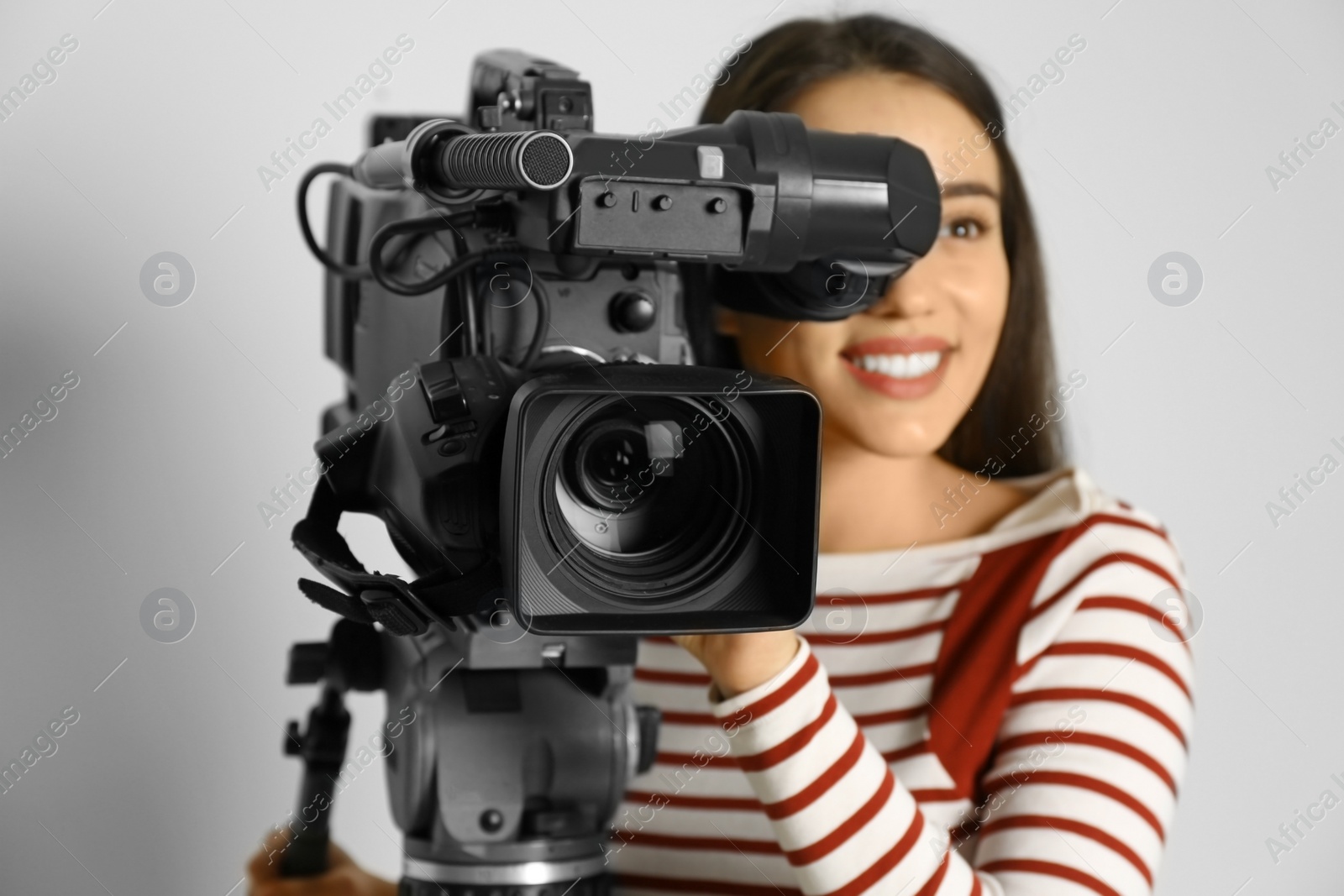 Photo of Operator with professional video camera on white background