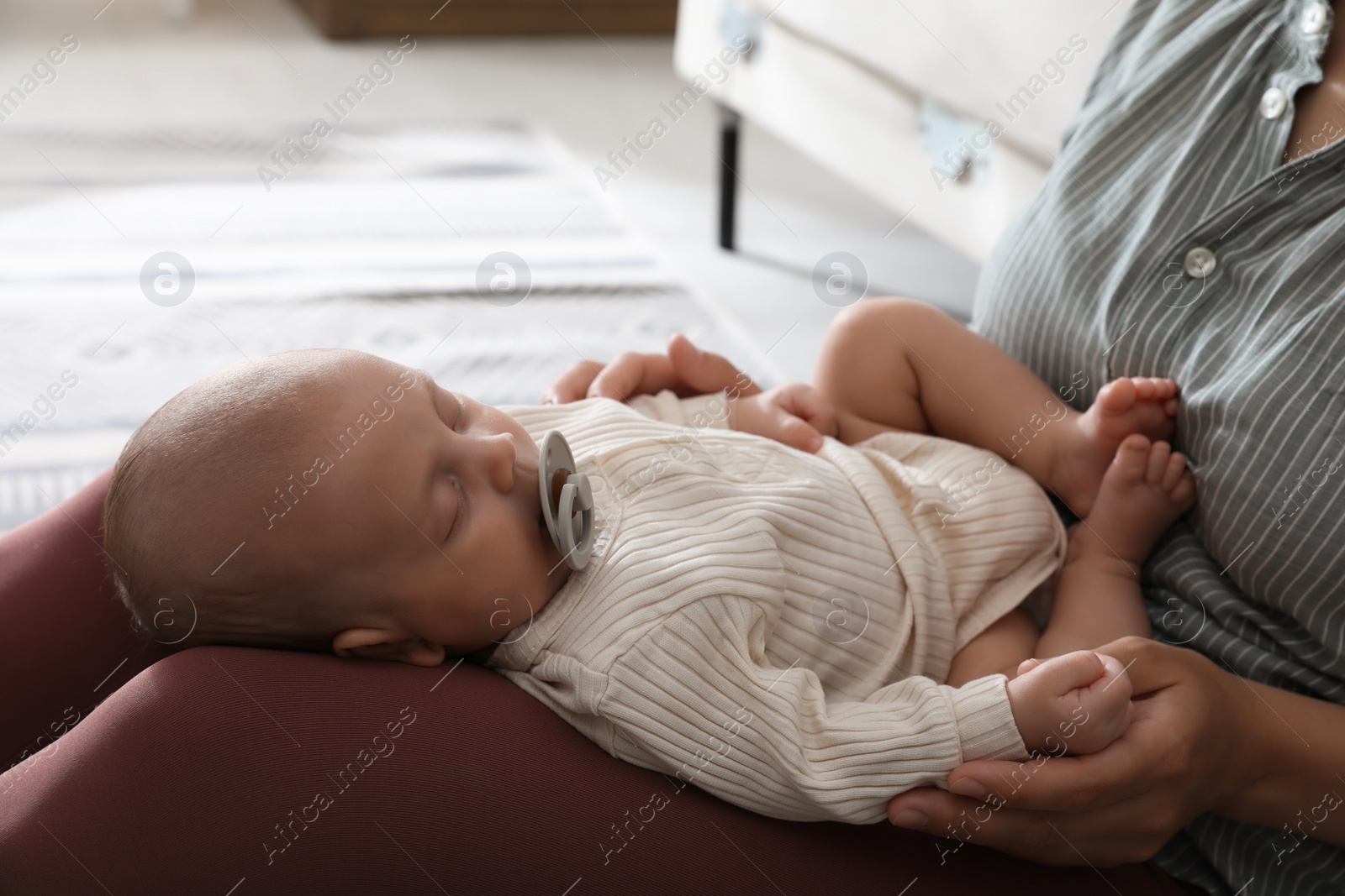 Photo of Mother with her cute sleeping baby at home, closeup