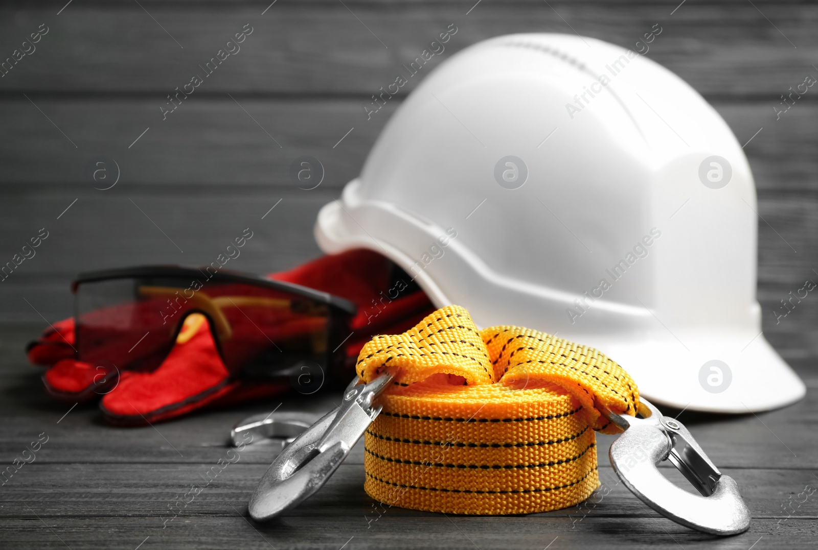 Photo of Yellow rope and blurred safety equipment on background. Space for text