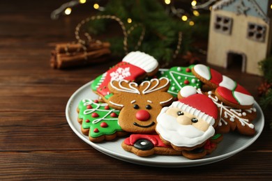 Photo of Different tasty Christmas cookies on wooden table, closeup. Space for text