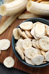 Photo of Freeze dried and fresh bananas on table, top view