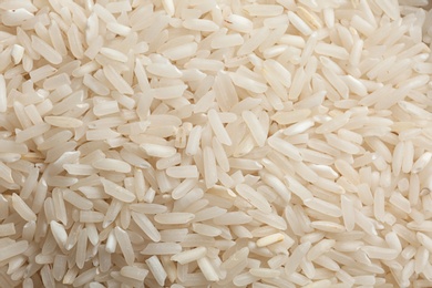 Raw long grain rice as background, closeup view