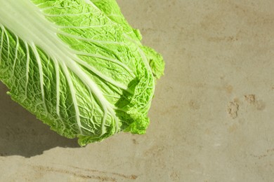 Photo of Fresh ripe Chinese cabbage on gray textured table, top view. Space for text