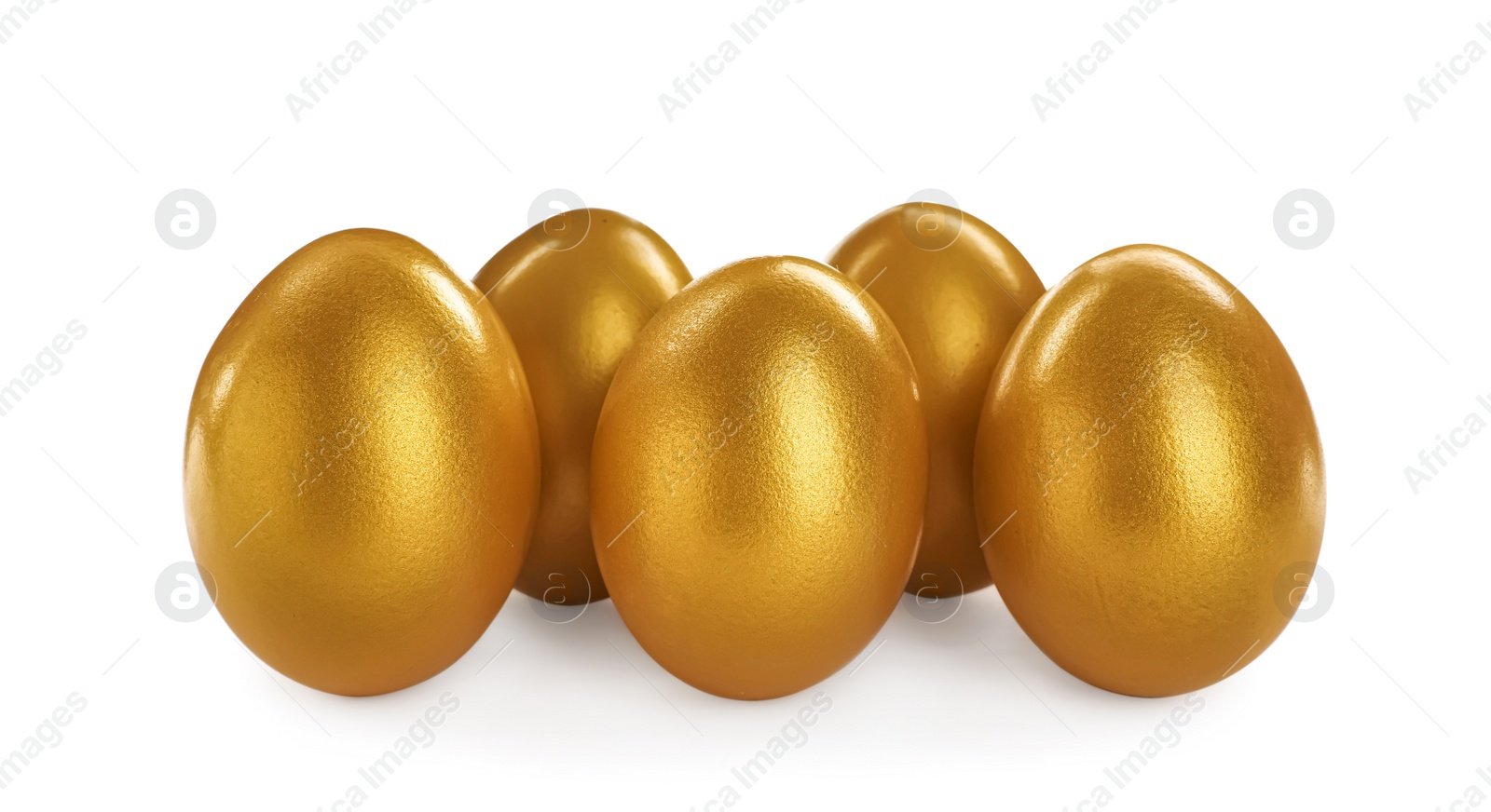 Photo of Many shiny golden eggs on white background