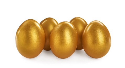 Photo of Many shiny golden eggs on white background