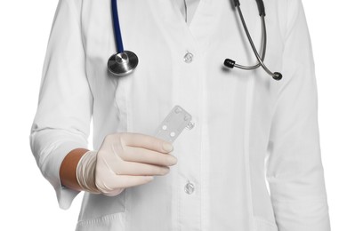 Doctor holding blister of emergency contraception pills on white background, closeup