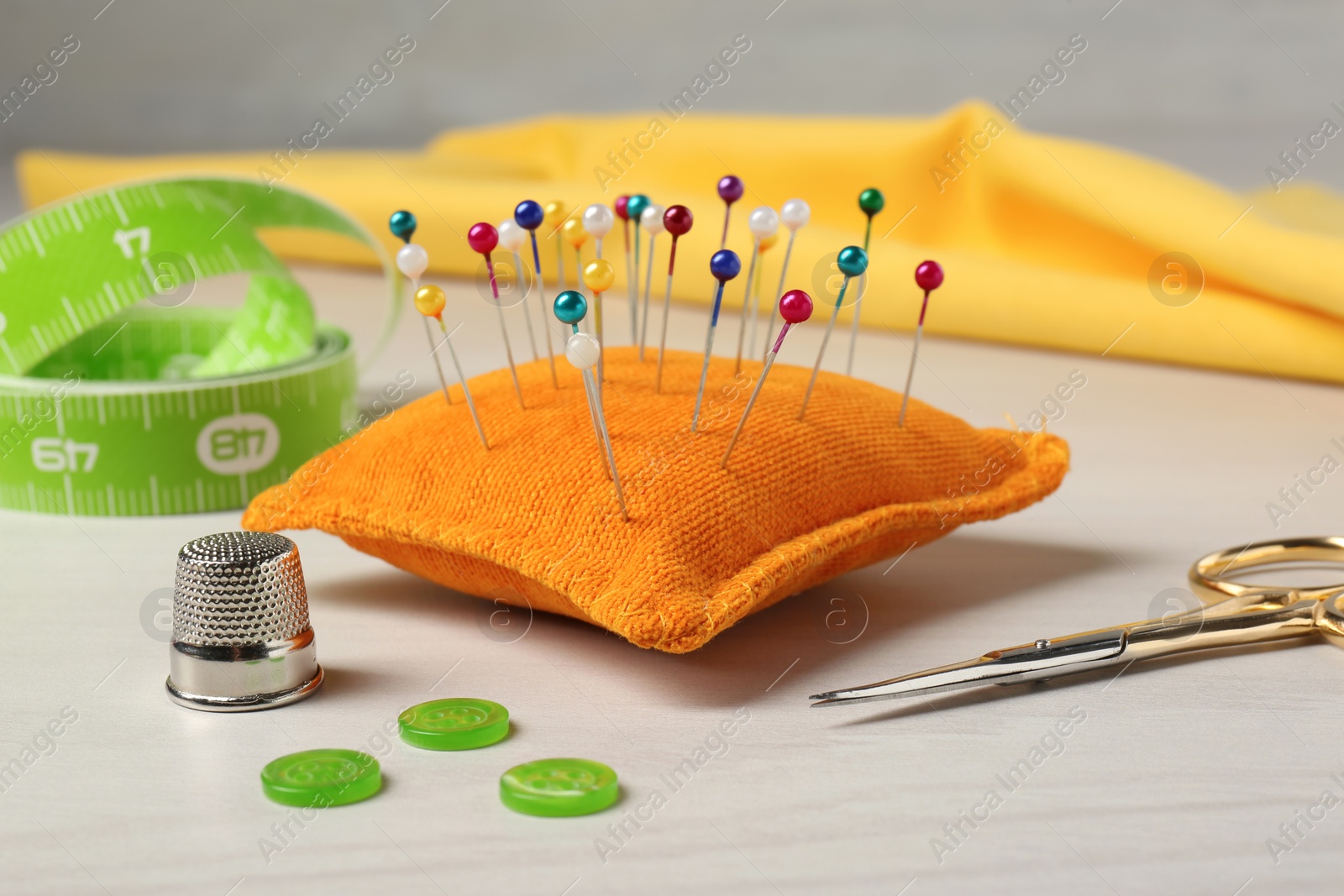 Photo of Set of sewing supplies and accessories on white table