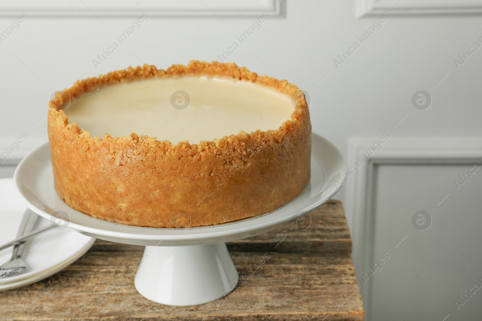 Photo of Tasty vegan tofu cheesecake on wooden table, space for text