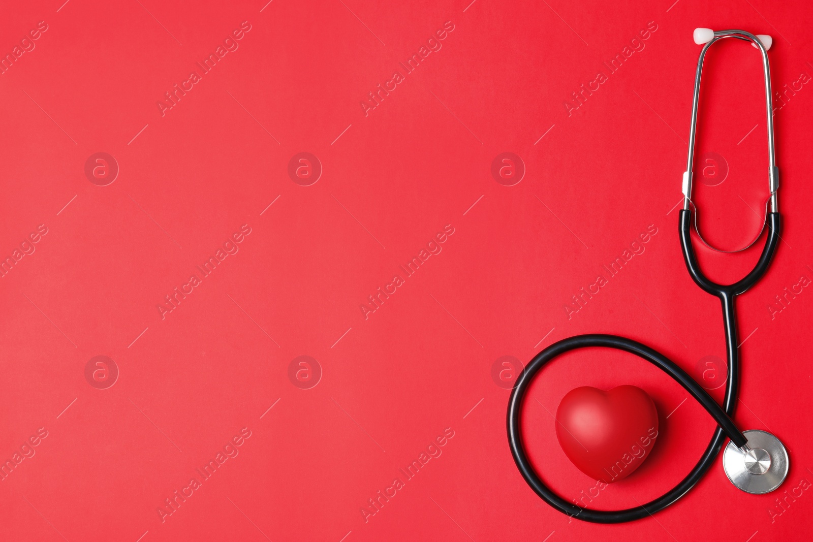 Photo of Stethoscope and red heart with space for text on color background, flat lay