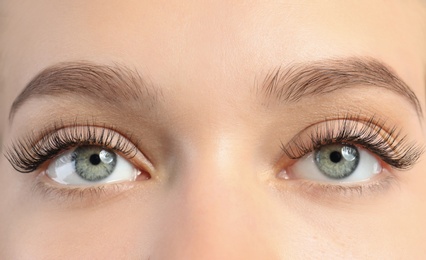 Photo of Young woman with beautiful long eyelashes, closeup. Extension procedure