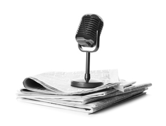 Photo of Newspapers and vintage microphone isolated on white. Journalist's work