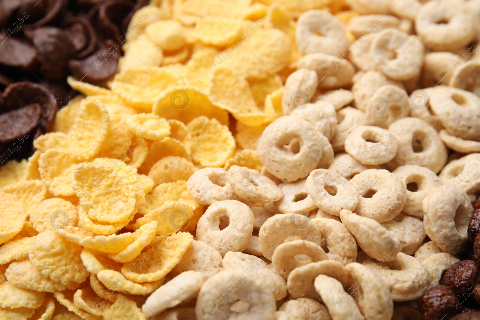 Photo of Different types of breakfast cereals as background, closeup