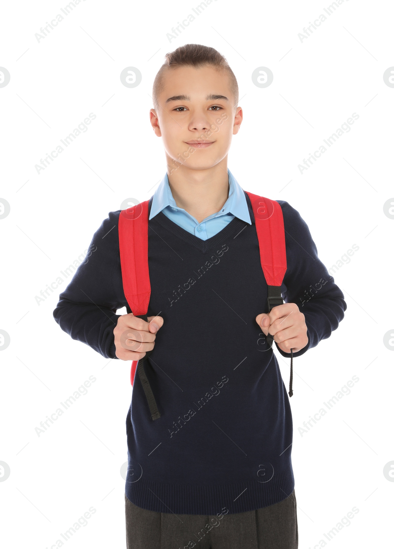 Photo of Portrait of teenage boy in school uniform with backpack on white background