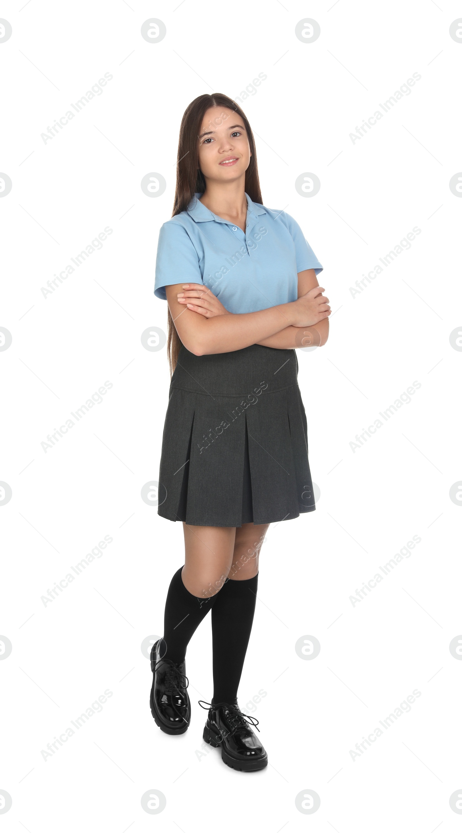 Photo of Teenage girl wearing school uniform on white background