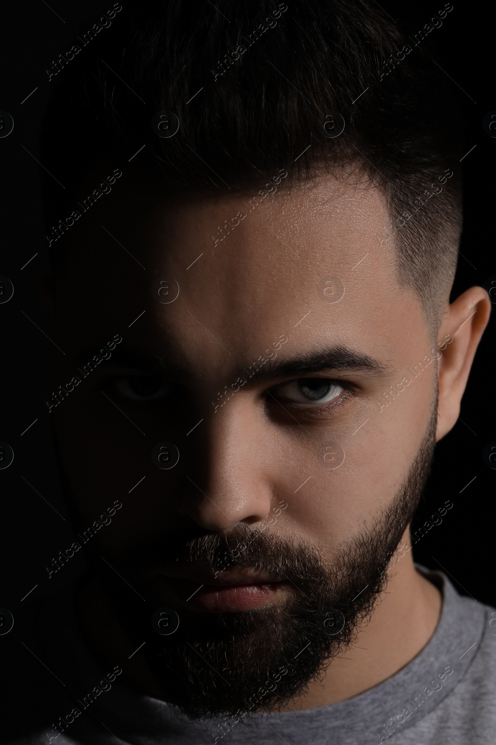 Photo of Evil eye. Man with scary eyes on black background