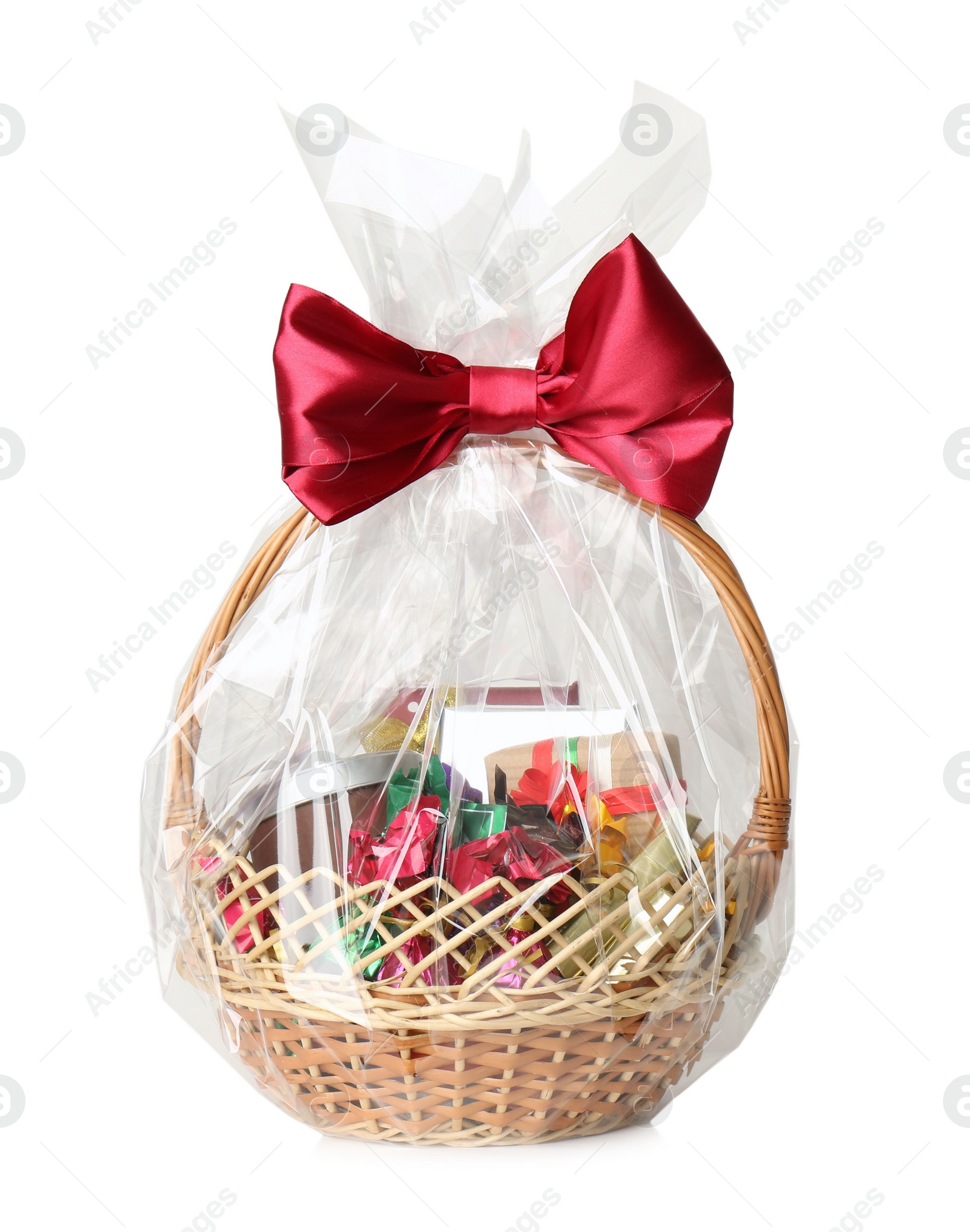 Photo of Wicker basket full of gifts isolated on white