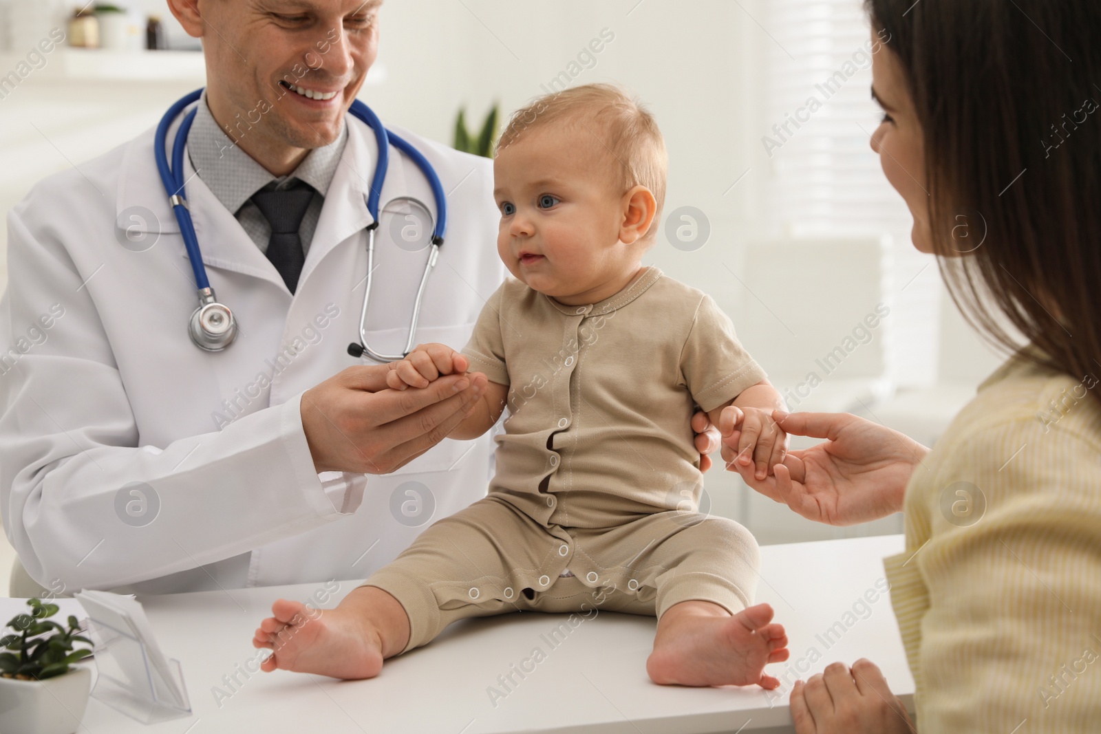 Photo of Mother with her cute baby visiting pediatrician in clinic