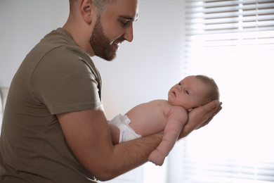 Father with his newborn son at home