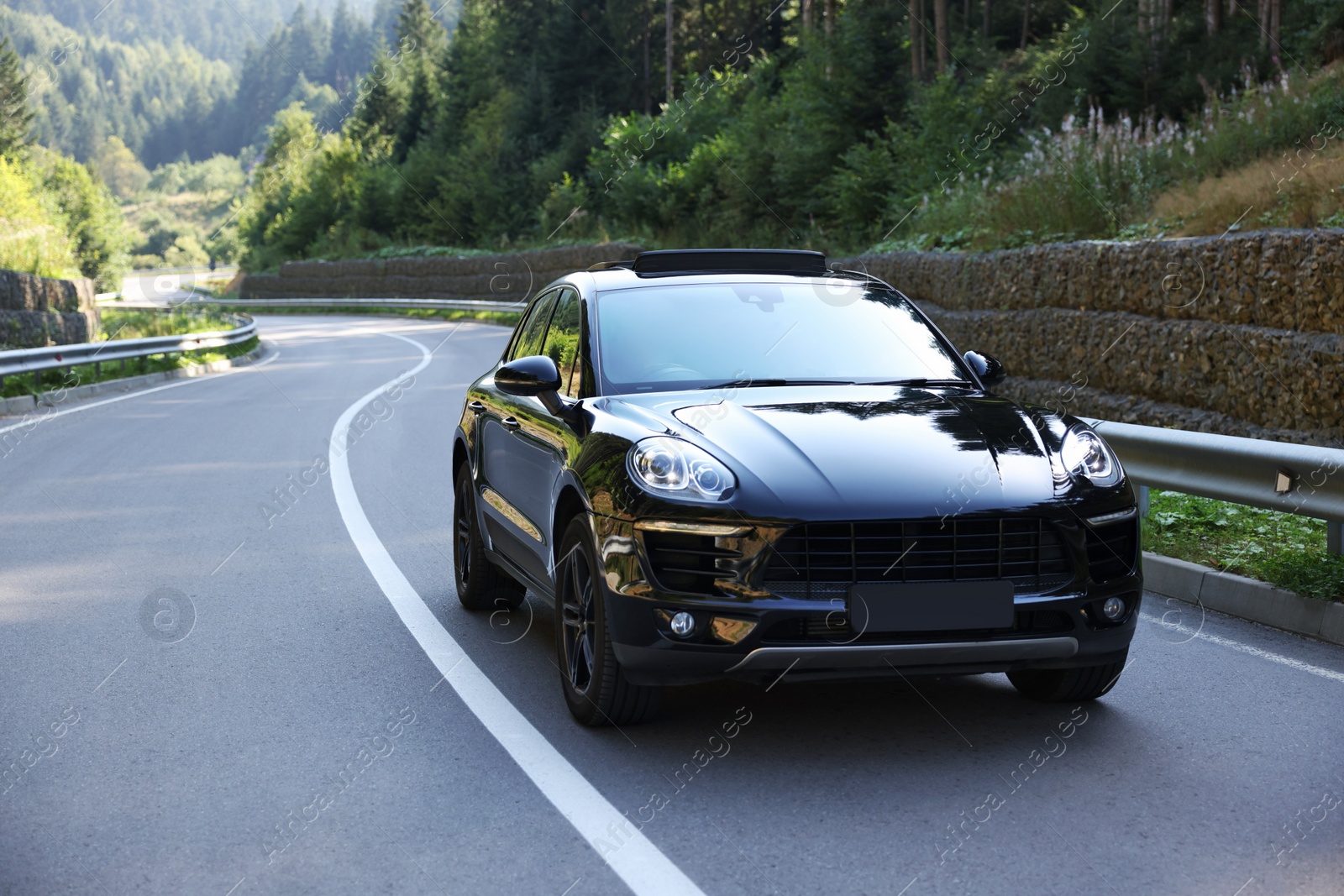 Photo of Picturesque view of asphalt road with modern black car outdoors