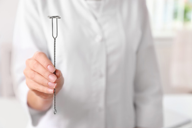 Photo of Speech therapist with logopedic probe in clinic, closeup. Space for text