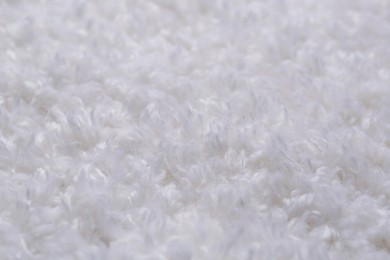 Photo of Soft white knitted fabric as background, closeup