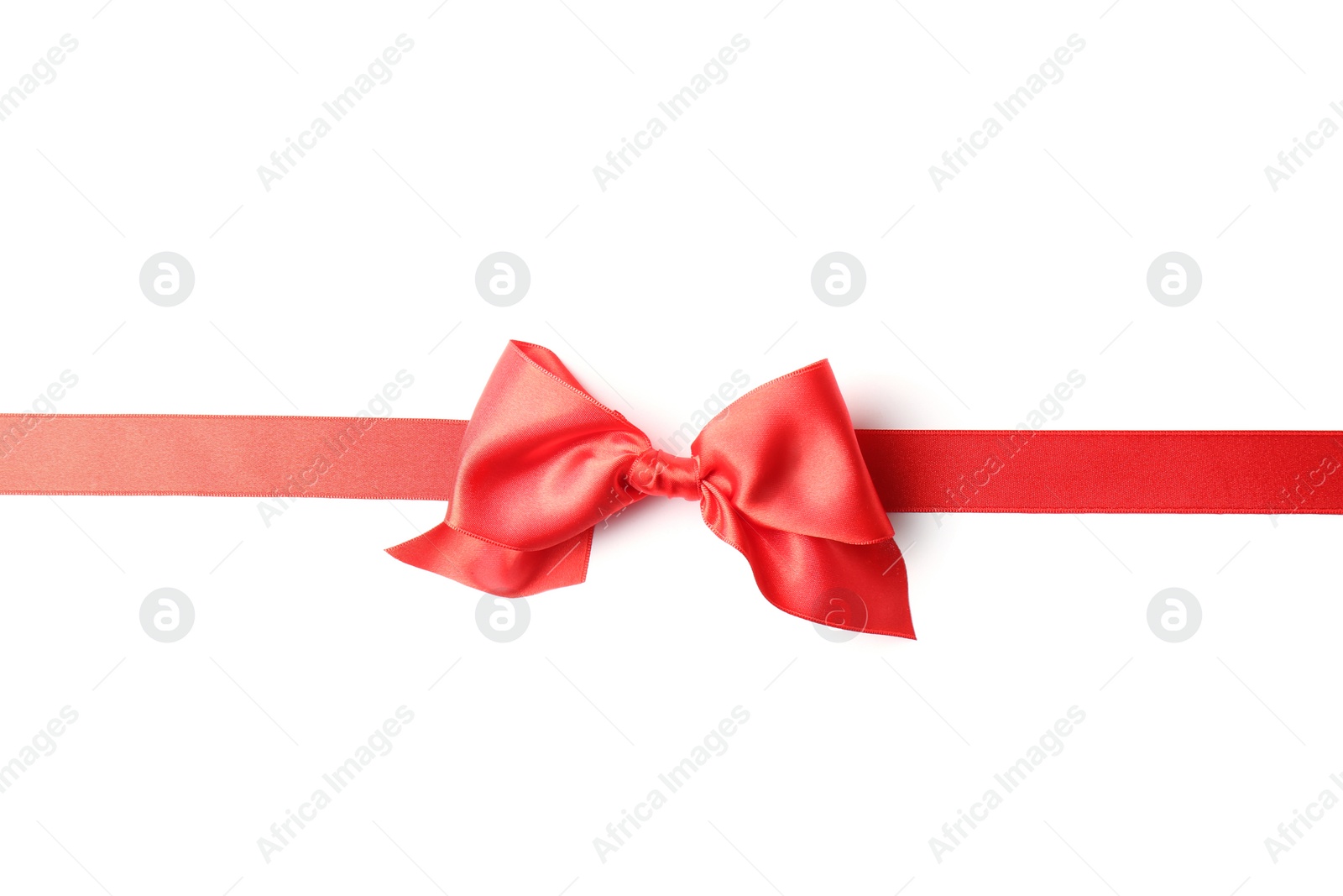 Photo of Red ribbon with bow on white background. Festive decoration