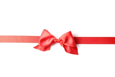 Photo of Red ribbon with bow on white background. Festive decoration