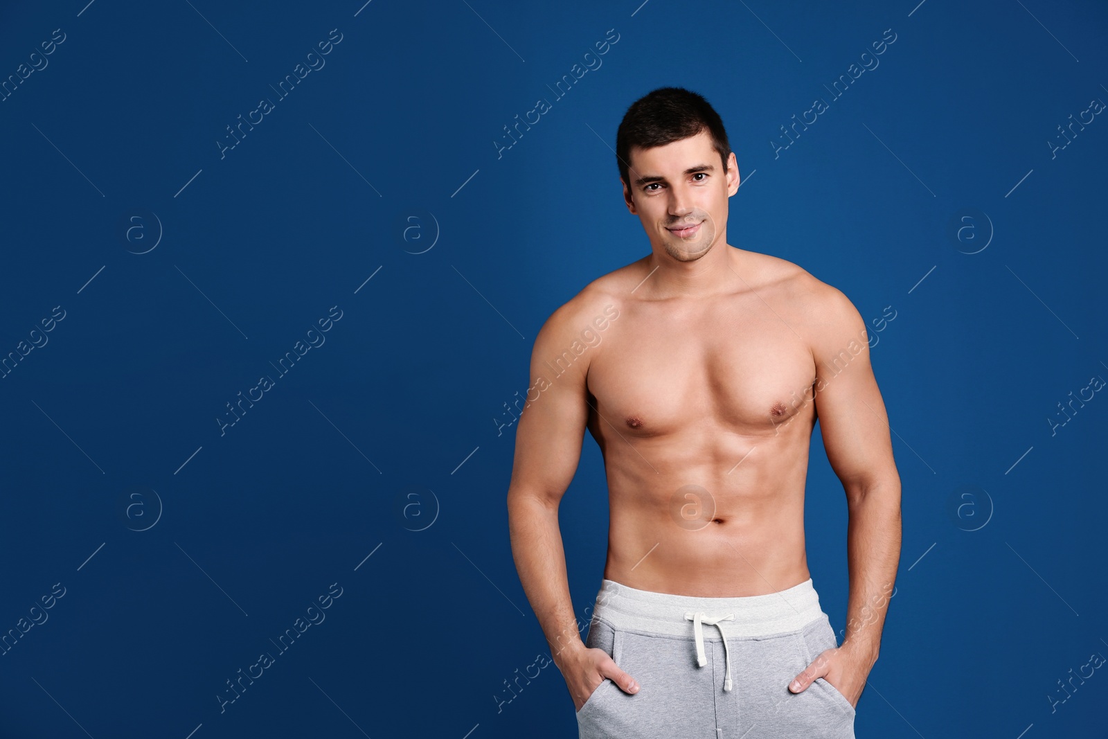 Photo of Man with sexy body on blue background