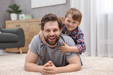 Photo of Family portrait of happy dad and son at home