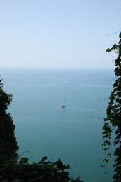 Picturesque view of green hills and sea with boat