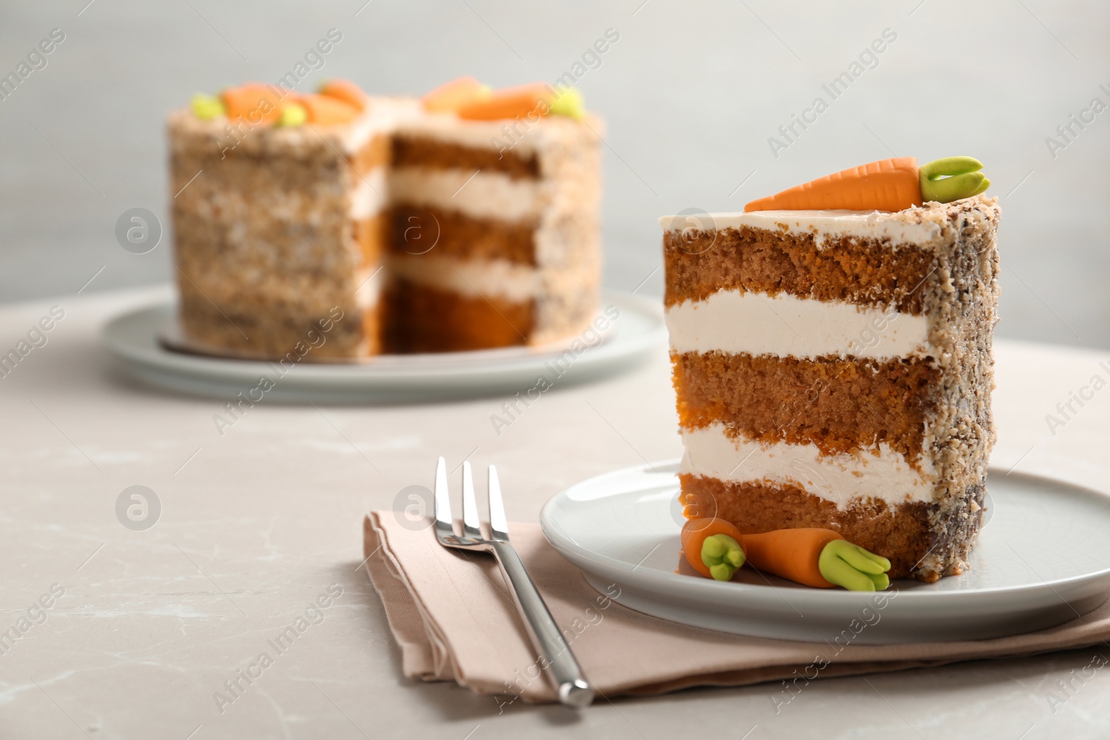 Photo of Sweet carrot cake with delicious cream on white table, space for text