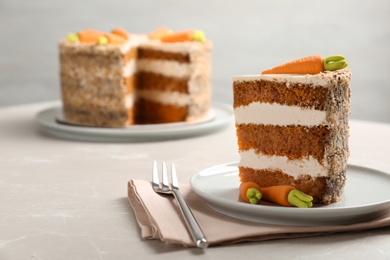 Photo of Sweet carrot cake with delicious cream on white table, space for text