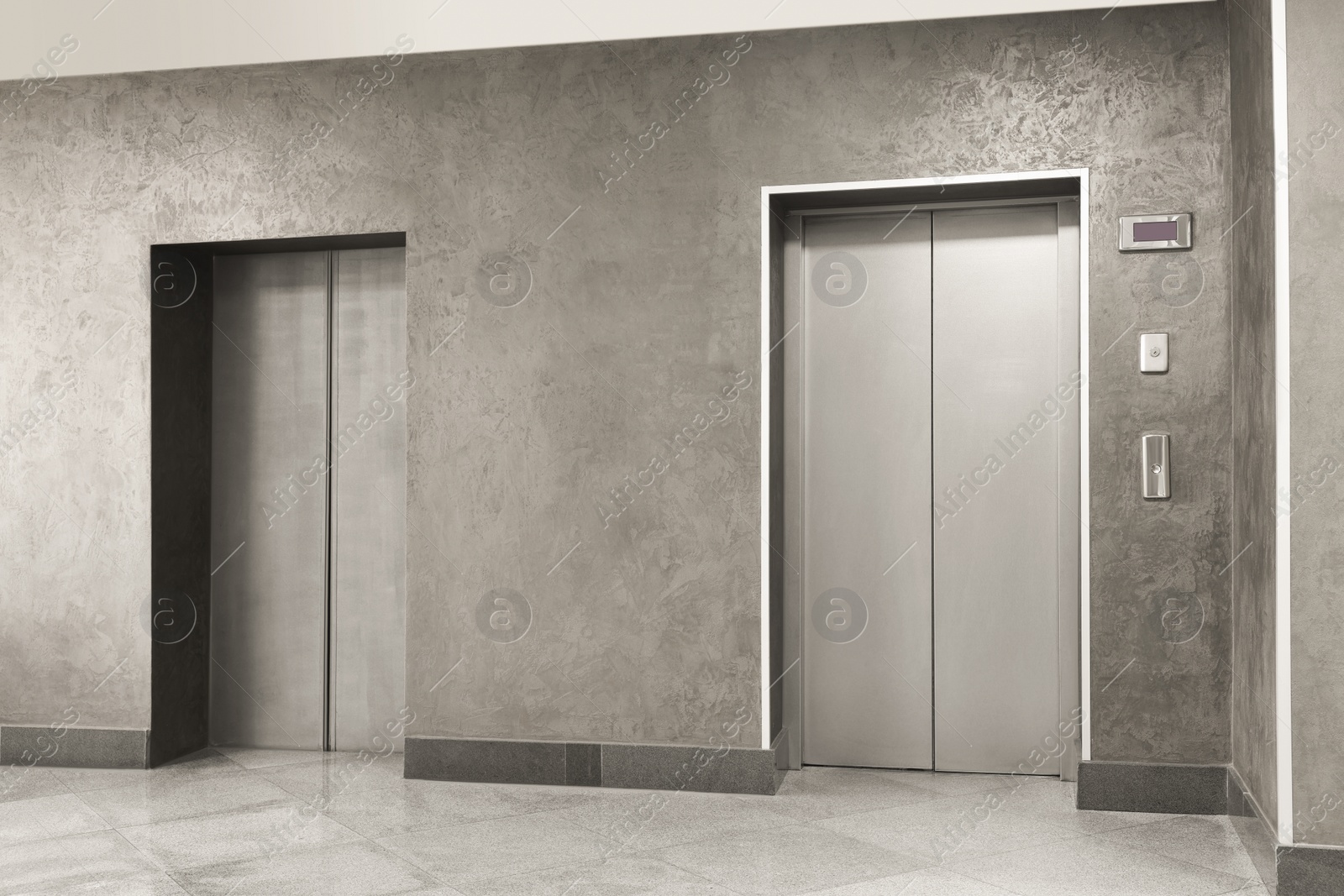 Photo of Closed stylish elevator doors in clean hall