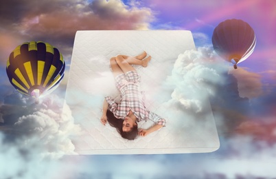 Image of Sweet dreams. Bright cloudy sky with hot air balloons around sleeping young woman