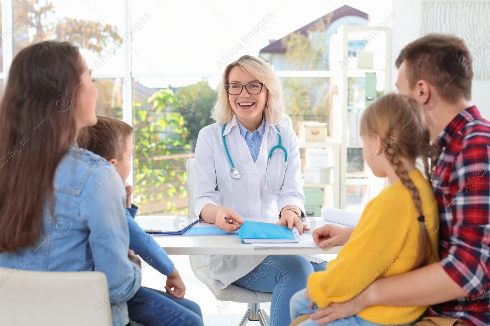 Photo of Little children with parents visiting doctor in hospital