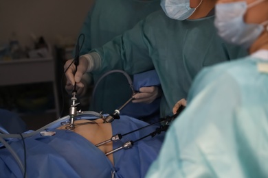 Photo of Medical team performing surgery in operating room, closeup