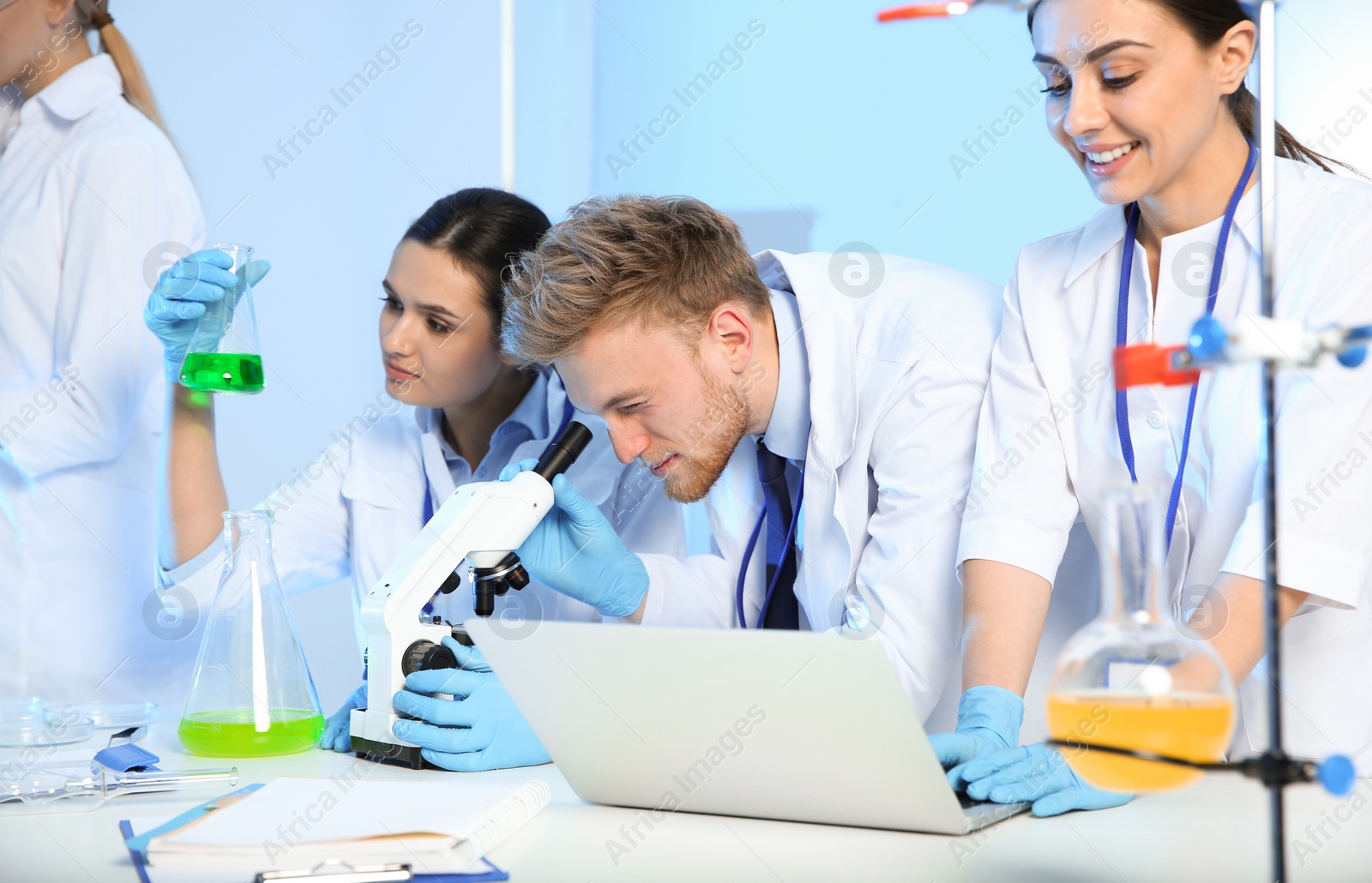 Photo of Group of scientists working in modern chemistry laboratory