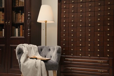Photo of Library interior with wooden furniture and comfortable place for reading