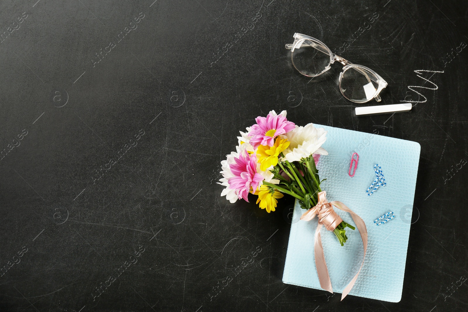 Photo of Flat lay composition for Teacher's day on chalkboard