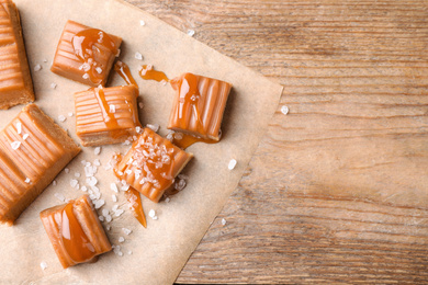 Salted caramel on wooden table, top view. Space for text