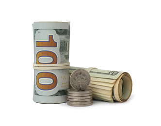 Rolled dollar banknotes and stack of coins on white background