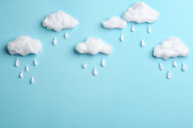 Photo of Clouds and raindrops made of cotton on blue background, flat lay. Space for text