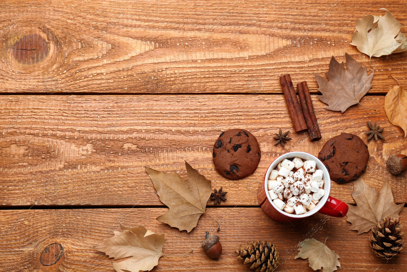 Photo of Flat lay composition with cup of hot drink on wooden table, space for text. Cozy autumn atmosphere