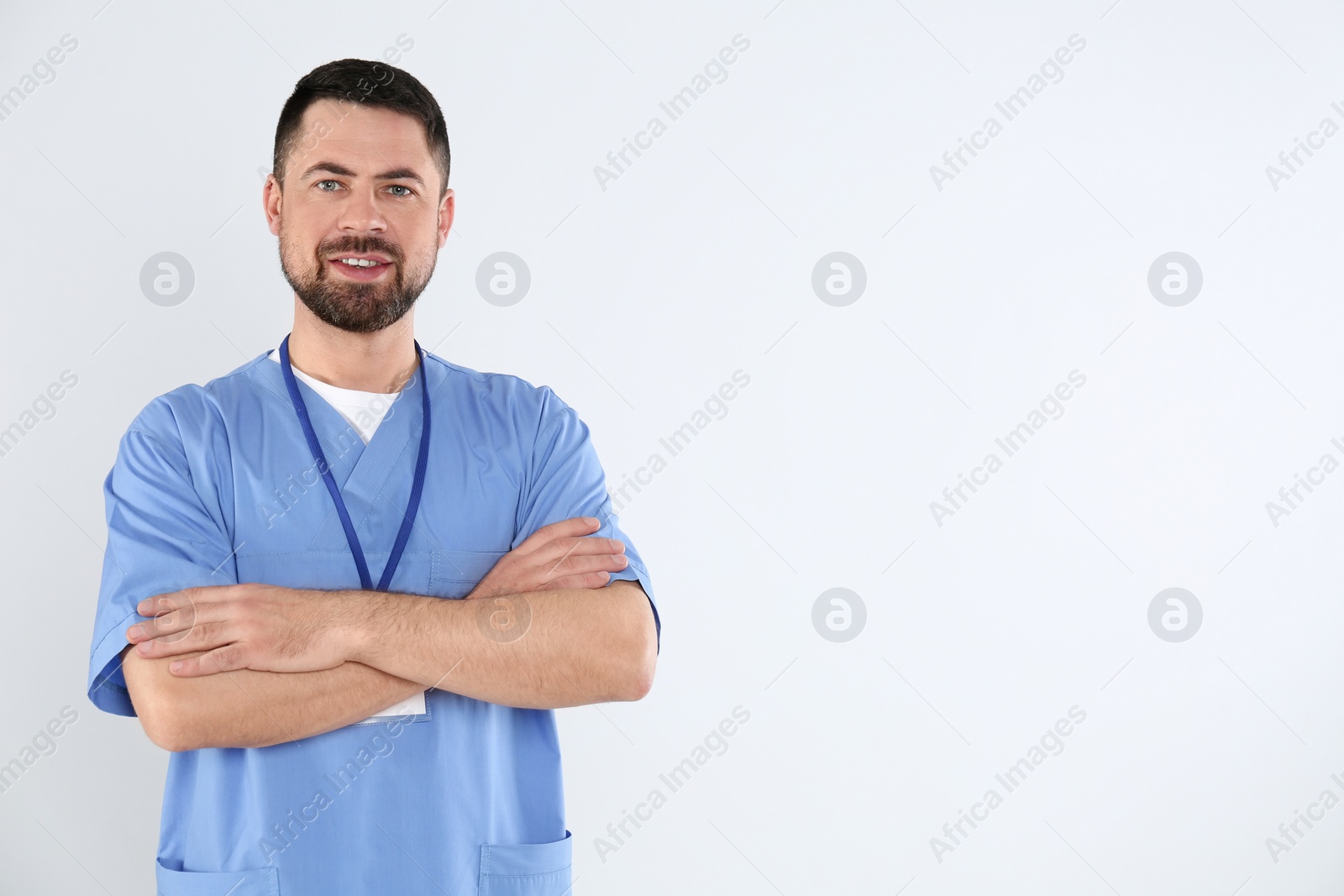 Photo of Portrait of mature doctor on white background