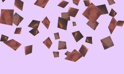 Image of Shiny bronze confetti falling on violet background. Banner design