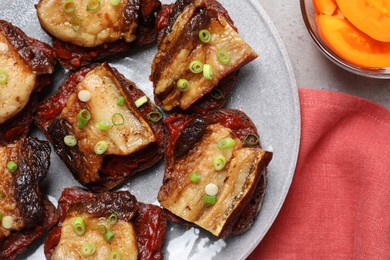 Tasty sandwiches with fried pork fatback slices on grey table, flat lay